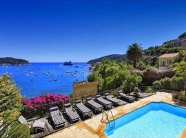 Looking across the pool and terrace with 8 sun loungers to Villefranche bay in the background.